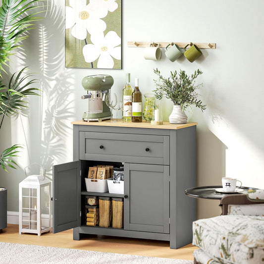 Grey kitchen cupboard with a drawer and double doors, styled in a dining room with coffee machine and wine bottles