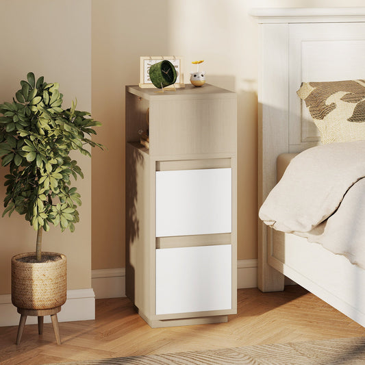 Slim bedside table in a bedroom next to a bed with a plant on the left