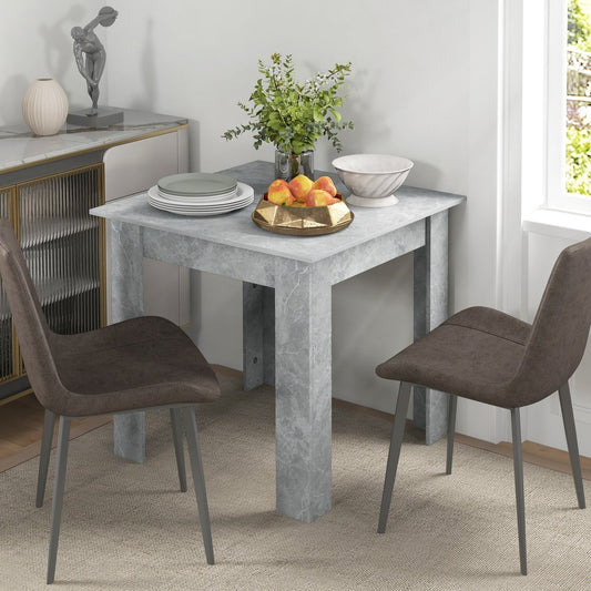 A small dining table set with two chairs in a dining room setting