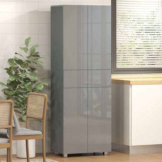 The kitchen furniture is shown in a room setting next to a window with chairs and a plant