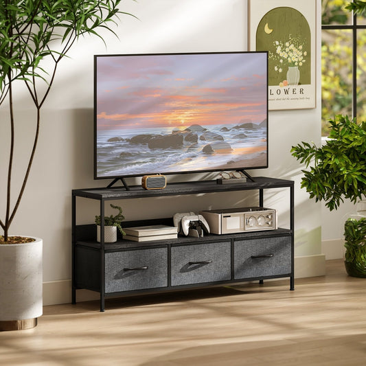The TV stand cabinet holding a television and various accessories in a bright living room
