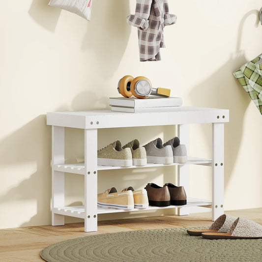 The shoe storage bench in a hallway with shoes on the shelves and a woman sitting on it