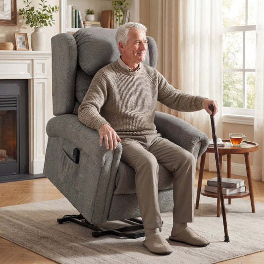 Elderly man sitting in the dark grey electric riser recliner chair, holding a walking stick