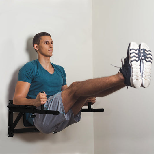 The pull up bar mounted on a wall with a man performing leg raises in a home gym setting