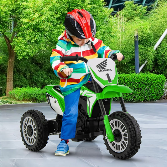The kids electric motorbike being ridden by a child wearing a helmet in an outdoor park