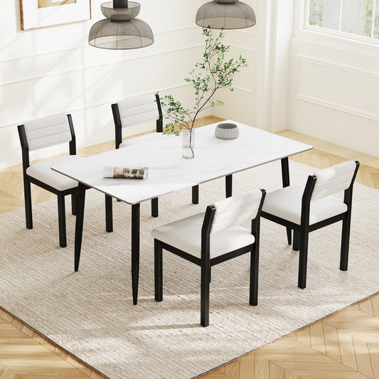 Four white upholstered dining chairs around a marble-effect dining table