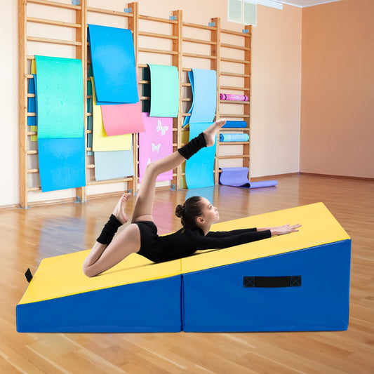 The yellow and blue gymnastics mat in use in a gym with a young girl stretching