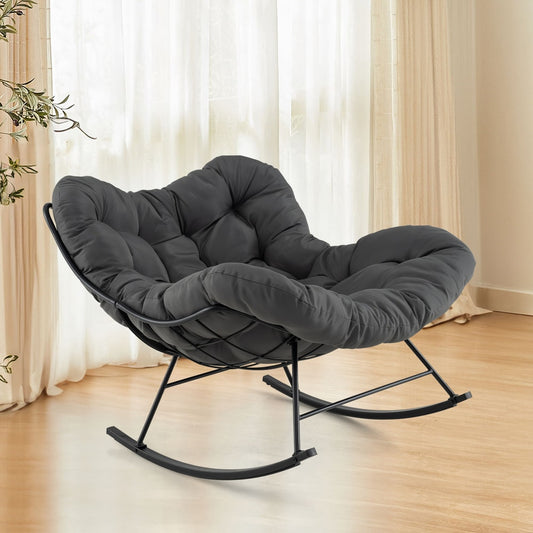 The grey rocking chair with a padded seat and backrest in a room setting
