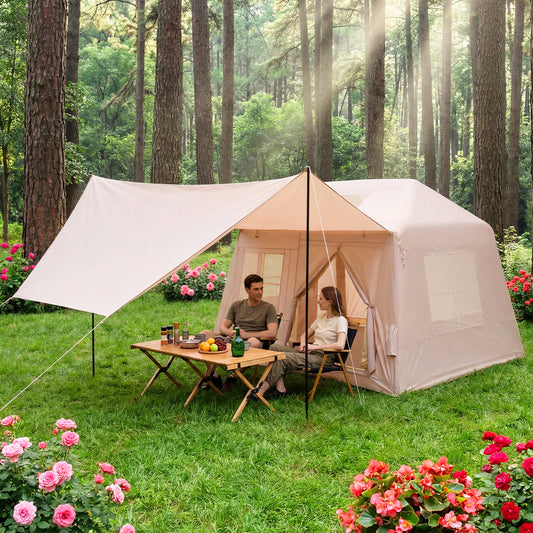 The inflatable camping tent set up in a woodland garden with a table and chairs