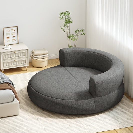 The round air sofa placed on a rug in a bright bedroom next to a bedside table
