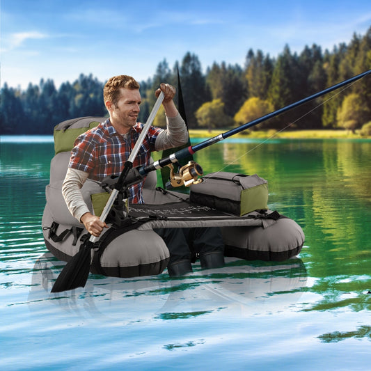 The fishing boat being used by a man on a calm lake with a fishing rod held in his hands