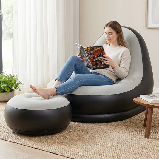 Woman reading a magazine while sitting on the inflatable sofa with ottoman in a living room