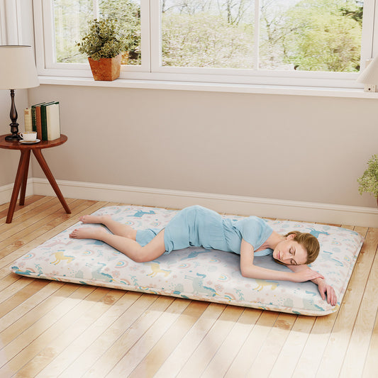 The floor mattress in use with a woman sleeping on it in a bright room