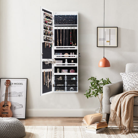 The white jewelry armoire with mirror is shown hanging on a wall in a bedroom setting