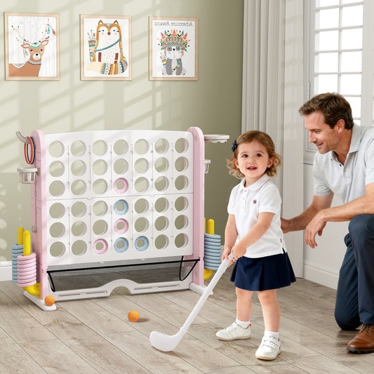 A father and daughter playing with the giant connect four game set indoors