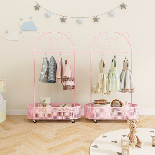 Two pink kids clothes racks with basket bases, one with dresses and the other with shirts