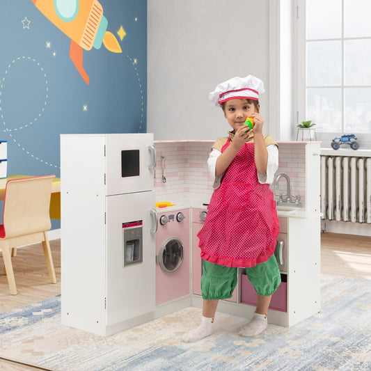 A young child wearing an apron and chef hat plays with the corner play kitchen in a room