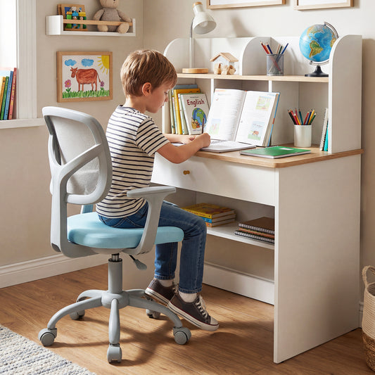 The kids chair positioned at a white desk with a child sitting and studying in a bedroom