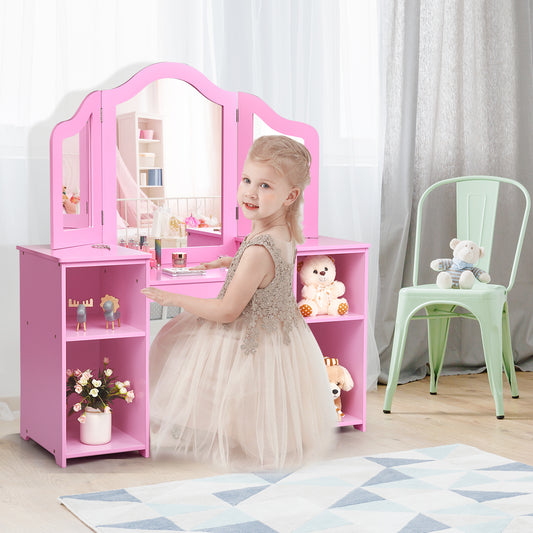 A young girl in a dress playing at the pink kids vanity table with mirror