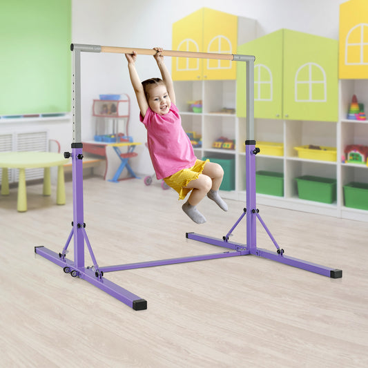 A young girl hanging from the wooden bar of the purple gymnastics equipment in a playroom