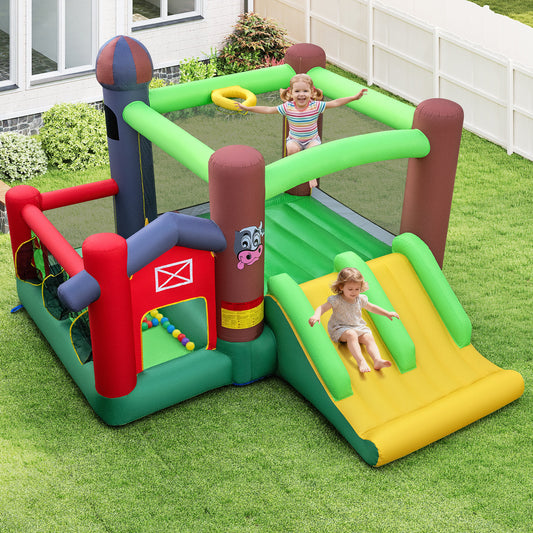 Children playing on the farm-themed bouncy castle with dual slides in a garden