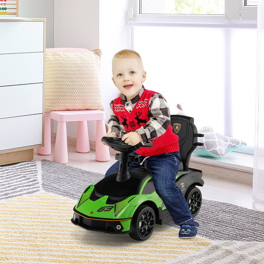 A young boy sits in the green ride on car, steering it
