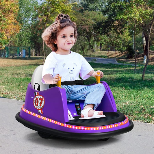 A young girl happily rides the purple electric car in a park setting