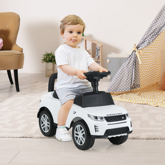 The white push toy being used by a young child in a bright indoor playroom setting