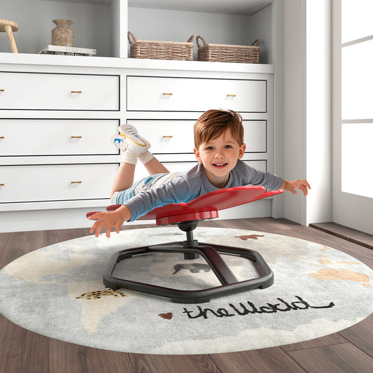The kids chair with a boy lying on his stomach on the red petal seat in a playroom