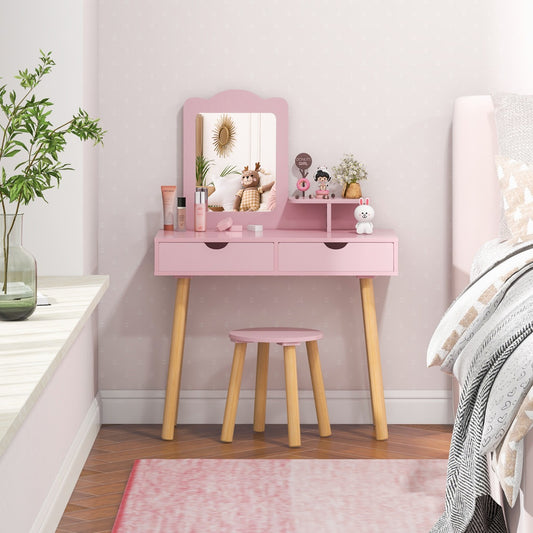 The pink kids vanity table and stool set is shown in a bedroom setting
