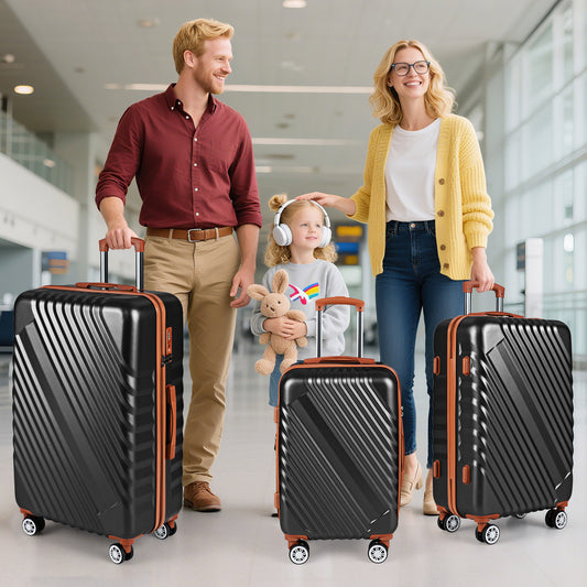 Three black suitcases of different sizes standing upright on a floor