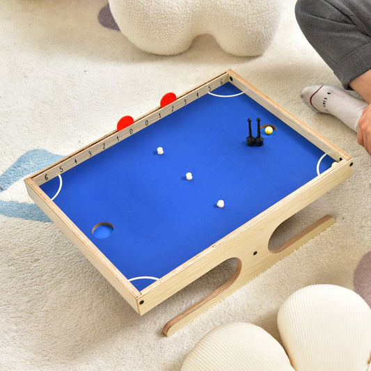 The magnetic mini foosball table on a rug with a person's legs visible