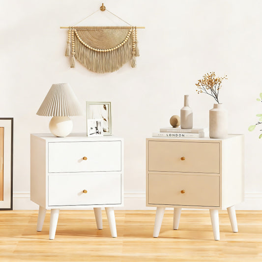 Two white bedside tables in a room with a lamp and pictures on top