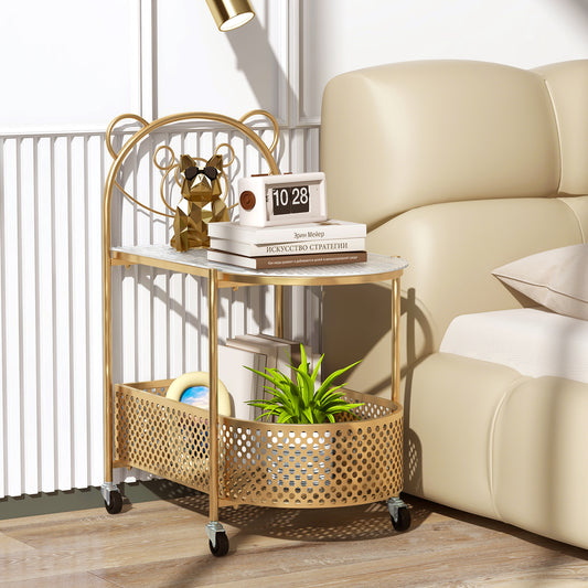 The golden end & side table with a bear pattern, styled with books and a plant next to a bed