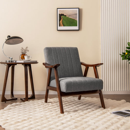 The accent chair placed in a bright living room next to a small side table and a lamp
