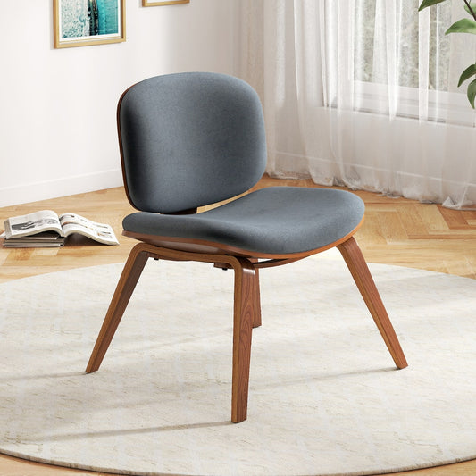 The modern accent chair is shown in a bright living room setting with a window behind