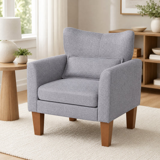 Grey fabric accent chair with wooden legs in a living room setting