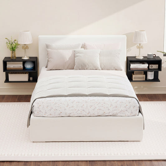 Two black floating nightstands mounted on a wall on either side of a bed