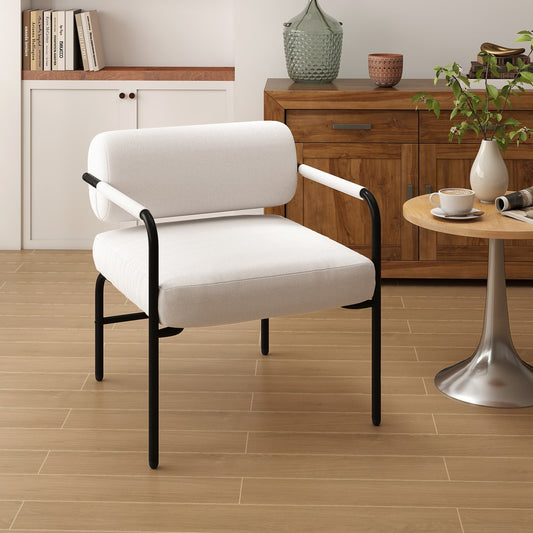 White upholstered accent chair with black legs in a room setting