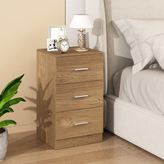 The nightstand end table next to a bed with a lamp and photos on top