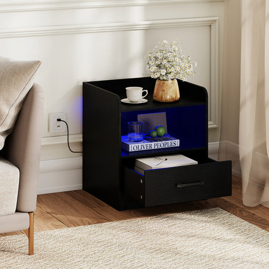 Black nightstand with open drawer next to a sofa