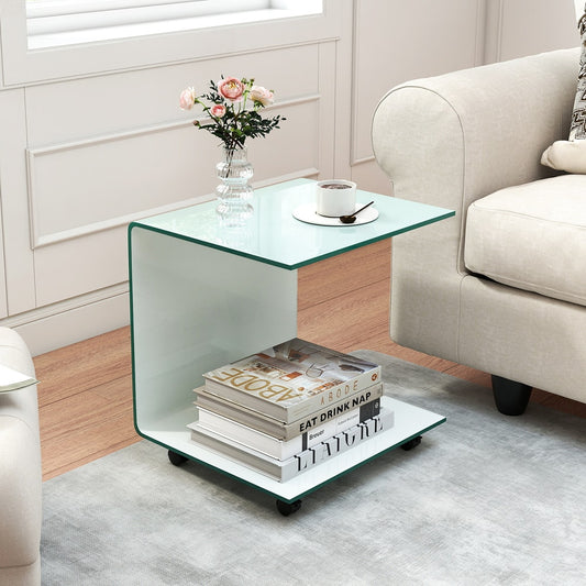 The white glass side table with wheels is shown next to a sofa with a book and flowers on top