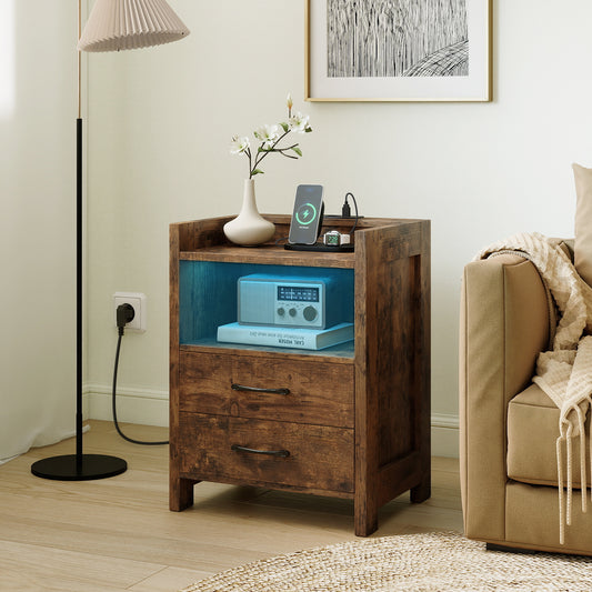 The nightstand placed next to a sofa in a living room with a lamp and decor on top