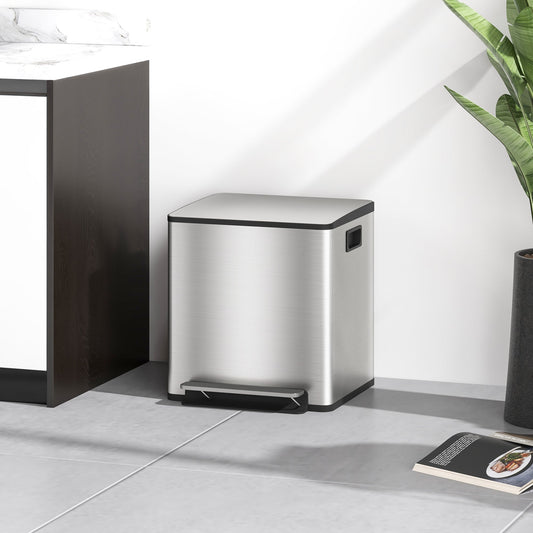 The stainless steel bin is shown in a kitchen setting next to a plant and a book