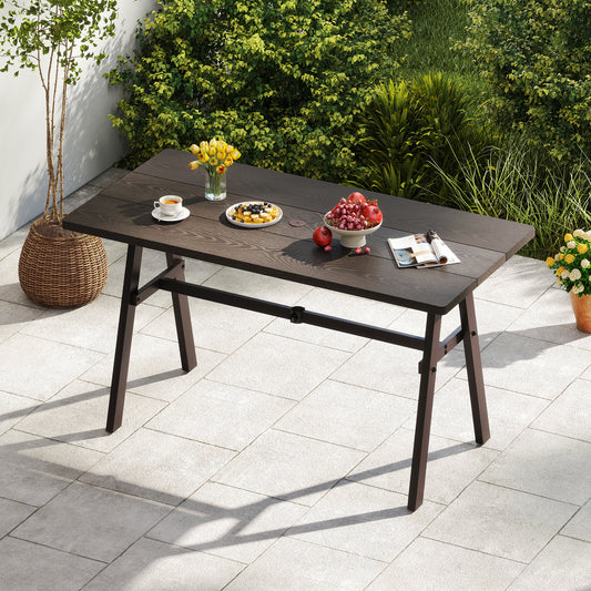 Outdoor Dining Tale, the patio table placed on a paved garden terrace with greenery