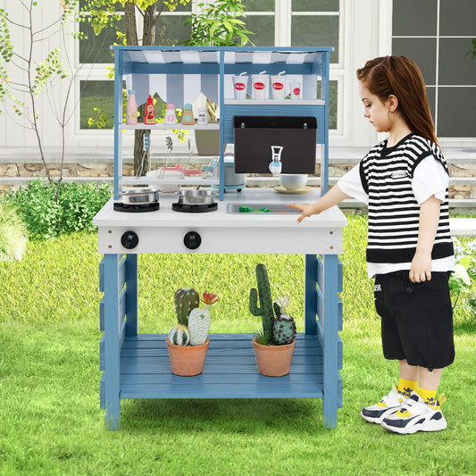 The play kitchen set standing on a lawn with a child playing at the sink area