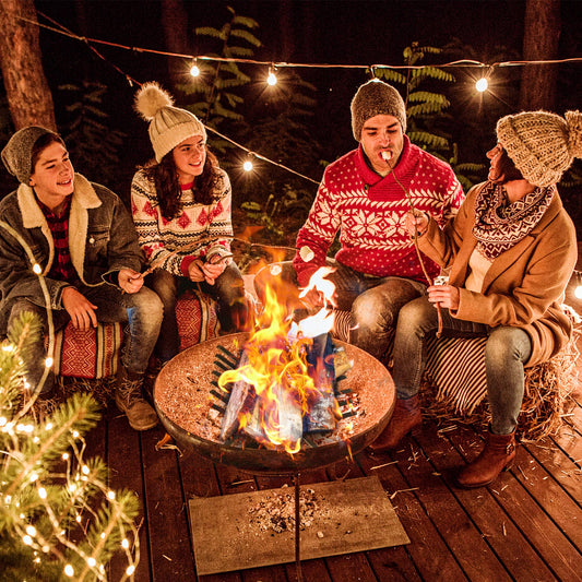 Family toasting marshmallows around a fire pit with the log grate holder