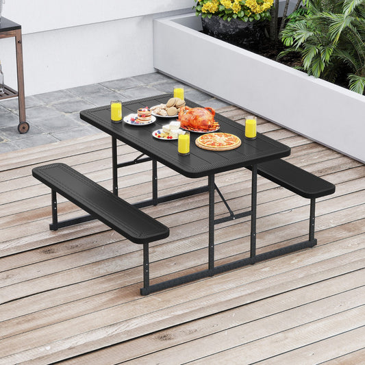 The patio tables set placed on a wooden deck with a meal served on the black tabletop