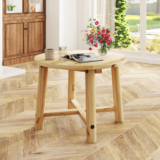 The patio table is placed on a wooden floor indoors, next to a sofa and a window