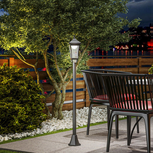 The garden lighting illuminating a patio area next to outdoor chairs at night